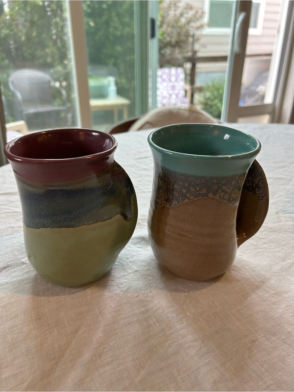 Lot of 2 Neher Art Pottery ceramic hand warmer mugs. Left/right handed. Signed.